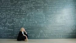 A person thinking at a board with formulas — illustration for an article about an idea exchange