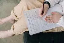 Filling in an assessment form by hand — illustration for an article about 360-degree assessment